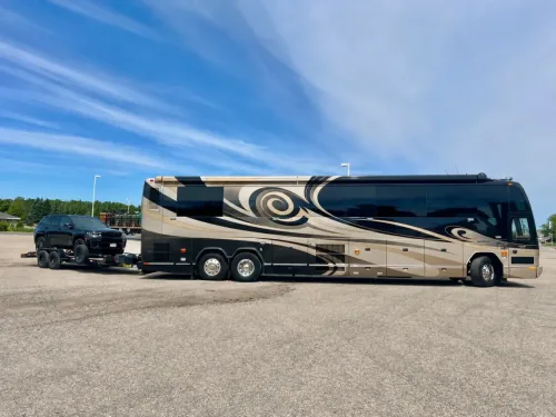 Large RV hauling our 20ft flatbed trailer with Jeep
