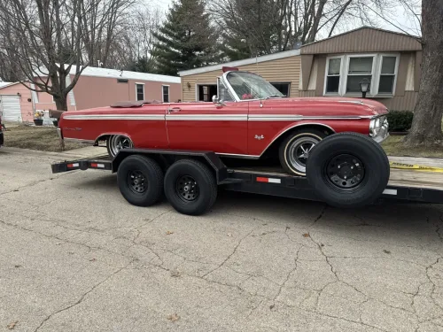 Classic car on a 20 foot flatbed trailer with winch