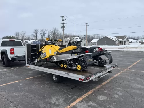 2 snowmobiles on snowmobile trailer