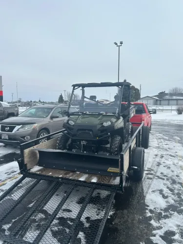 UTV with plow in our 12’ utility trailer