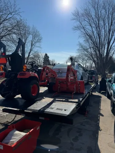 Chevy Cruze and tractor on our 24ft deckover trailer