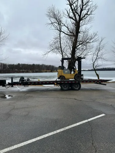 Transporting forklift with our 24 foot deck cover tilt trailer