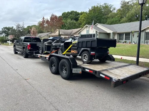 Two golf carts on our 20ft flatbed trailer
