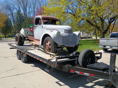 Old dually truck on our 24' deckover tilt trailer
