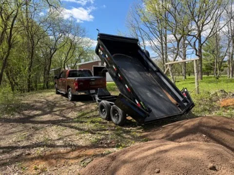 Our 6x12' dump trailer dumping topsoil