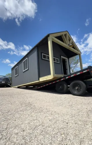 Unloading 12x24' shed on our 24ft deckover trailer