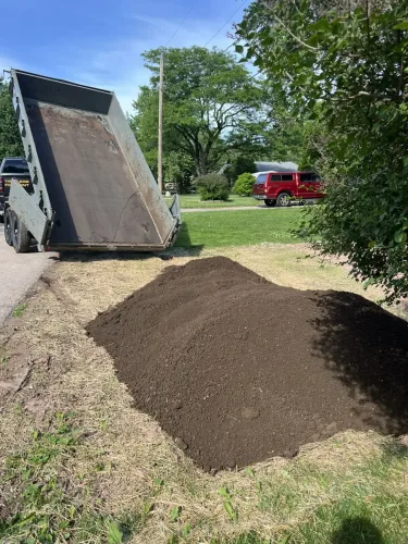 Our 7x14' dump trailer dumping top soil