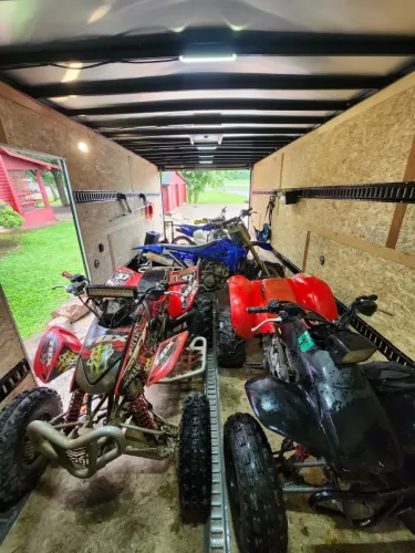 8.5x20' enclosed trailer hauling UTVs, ATVs, and dirtbikes