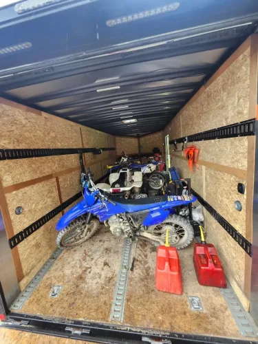 8.5x20' enclosed trailer hauling UTVs, ATVs, and dirtbikes