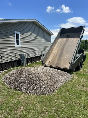 Our 7x14' dump trailer dumping 3/4 river rock