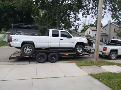 Chevy truck on 20ft flatbed trailer