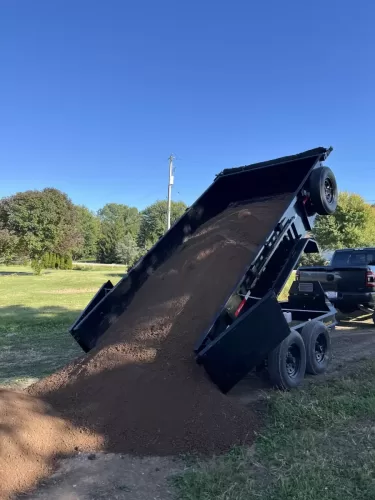 7x14' dump trailer with 5 yards of top soil
