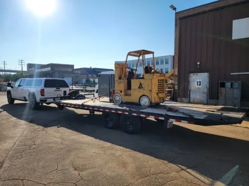 Our 24ft deckover tilt trailer hauling a forklift