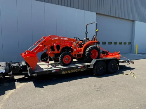 Our 20ft flatbed trailer hauling a Kubota tractor