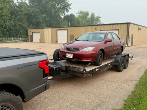 Our 20ft flatbed car hauler hauling a car