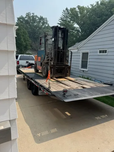 Our 24ft deckover tilt trailer hauling a forklift