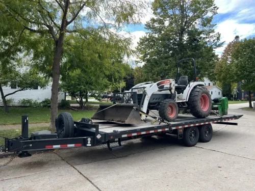 Bobcat tractor on our 24' deckover tilt trailer
