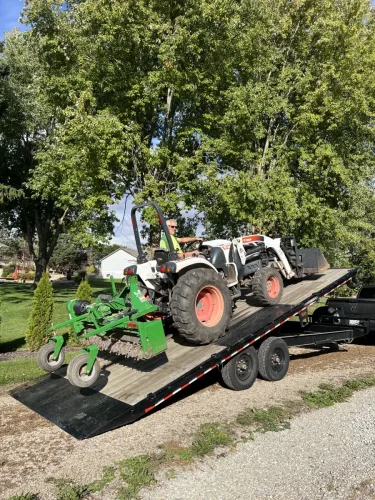 Bobcat tractor on our 24' deckover tilt trailer