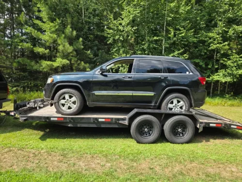 Our 20ft flatbed trailer hauling a Jeep Cherokee