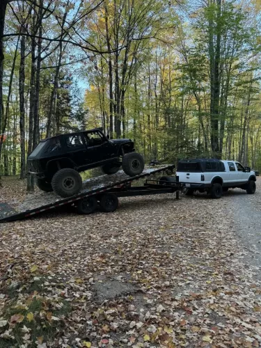 Off-road Jeep on 24ft deckover tilt trailer